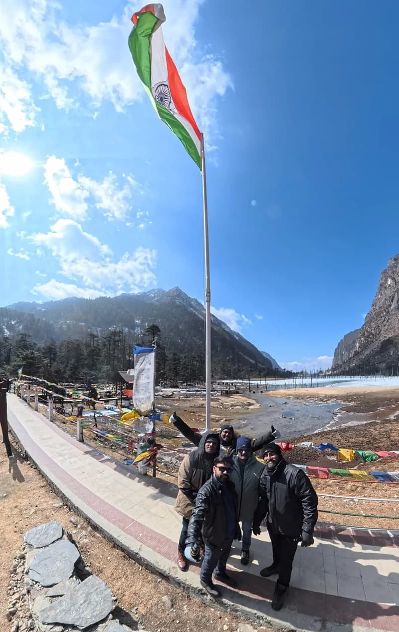 Five travellers under the Indian flag beside the frozen Sangetsar Lake near Tawang