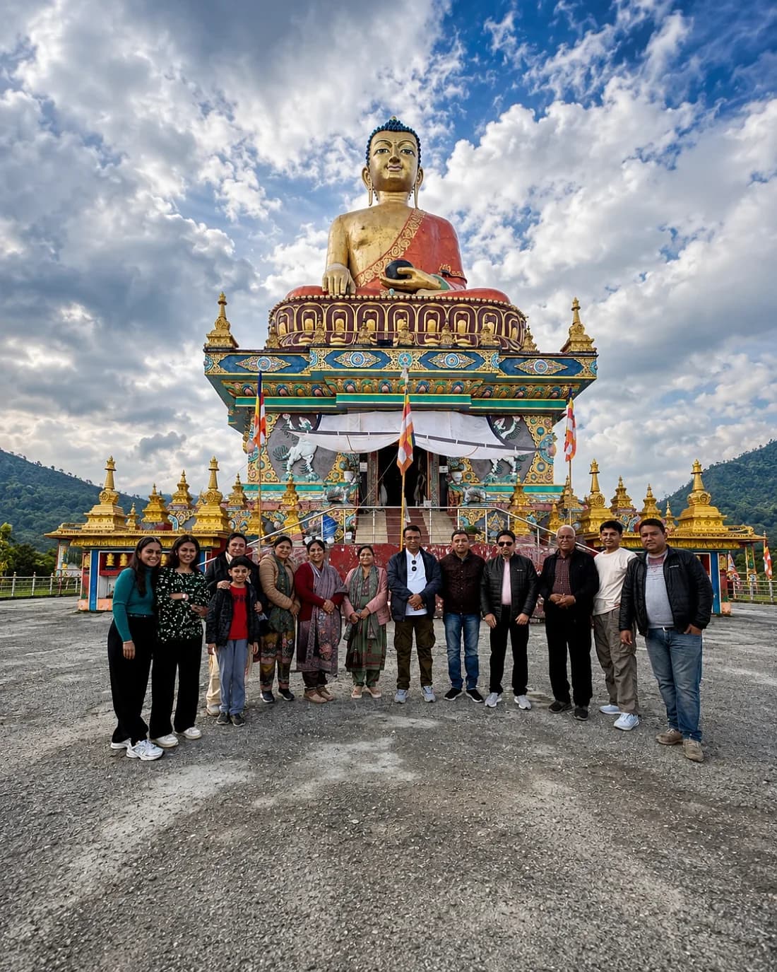 The group below a large gilded seated Buddha ringed with golden stupas