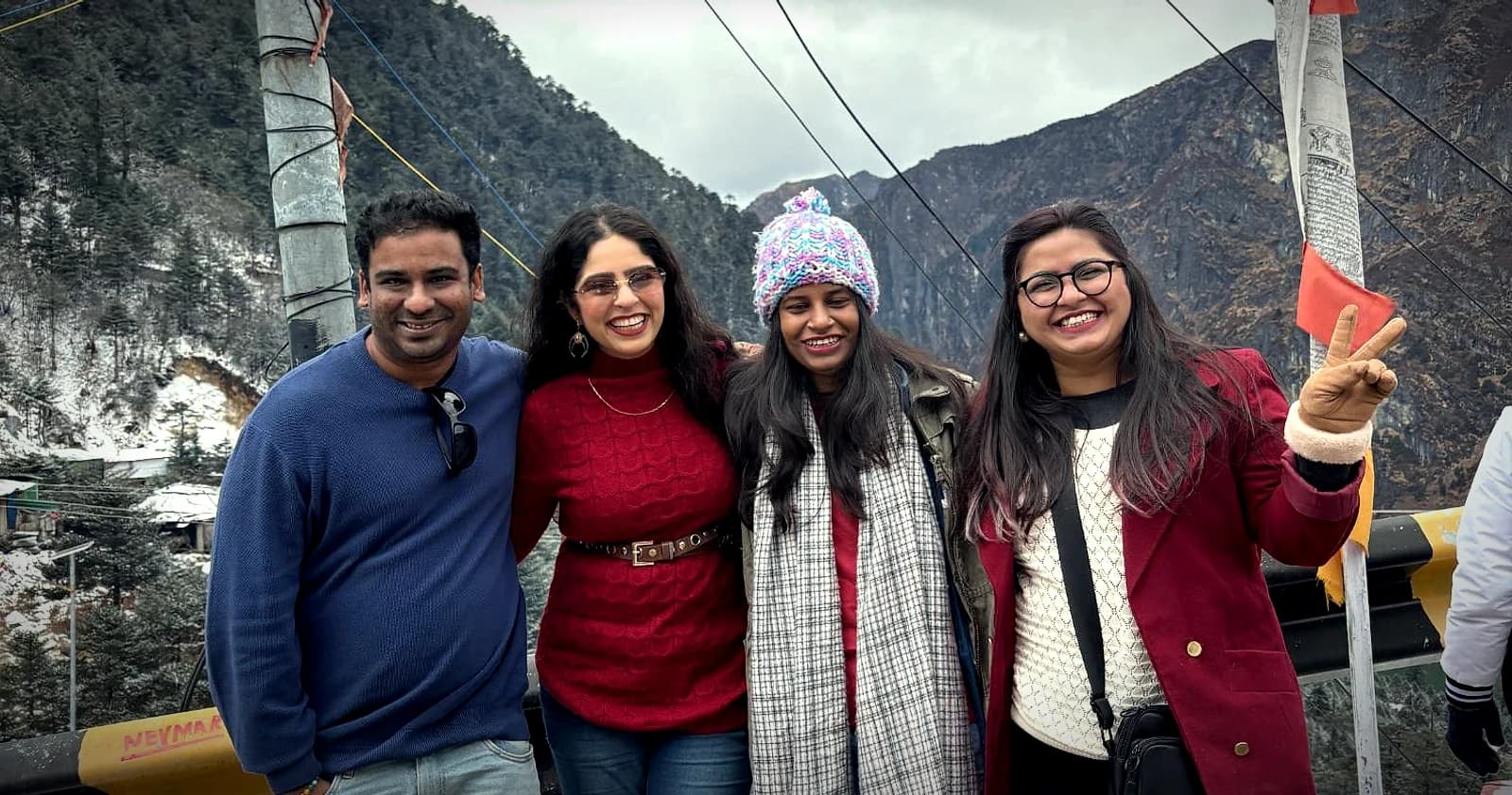 A group on a snow-lined mountain road near Tawang