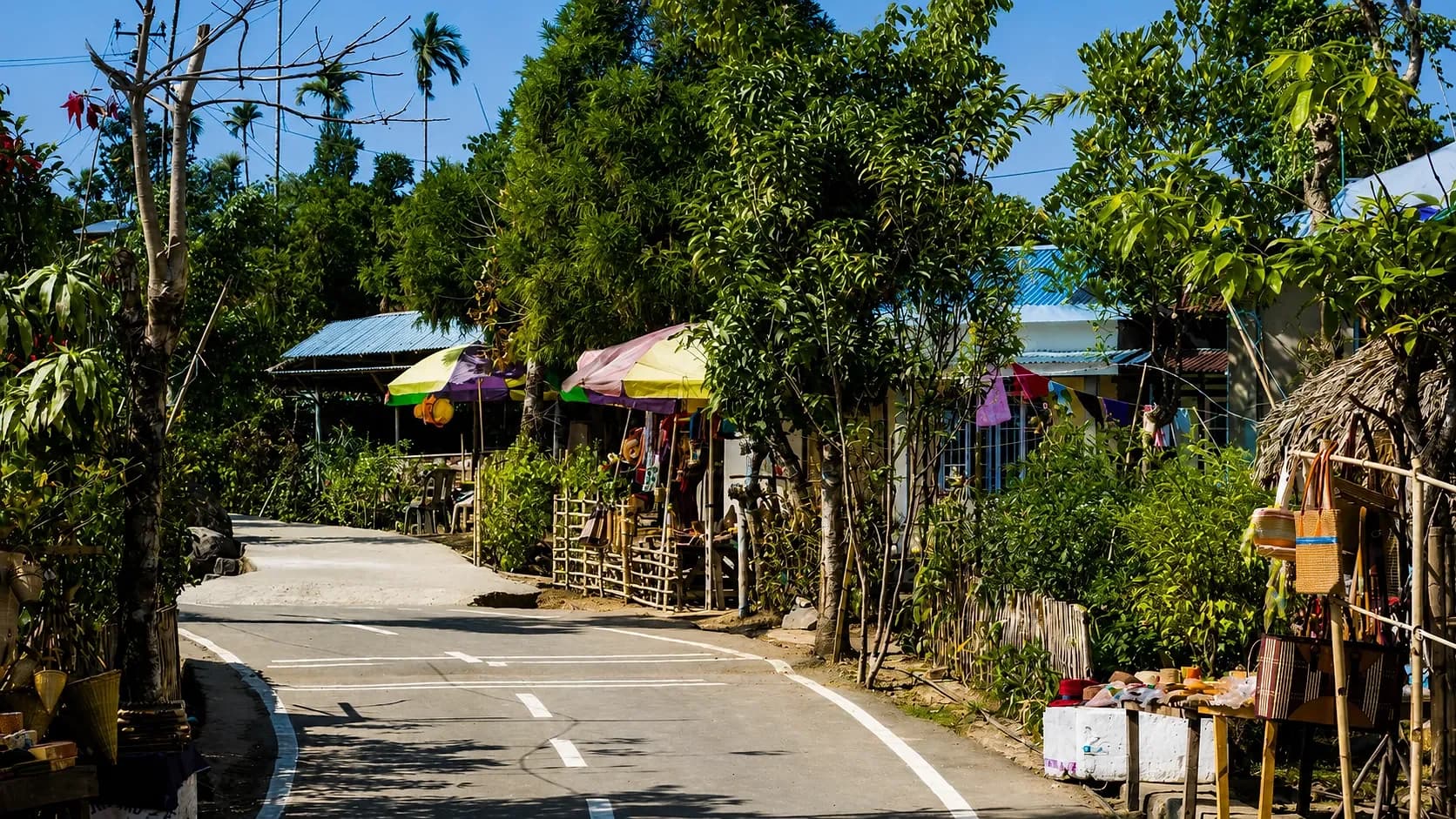 The village street at Mawlynnong, swept clean and lined with shaded stalls and cane baskets