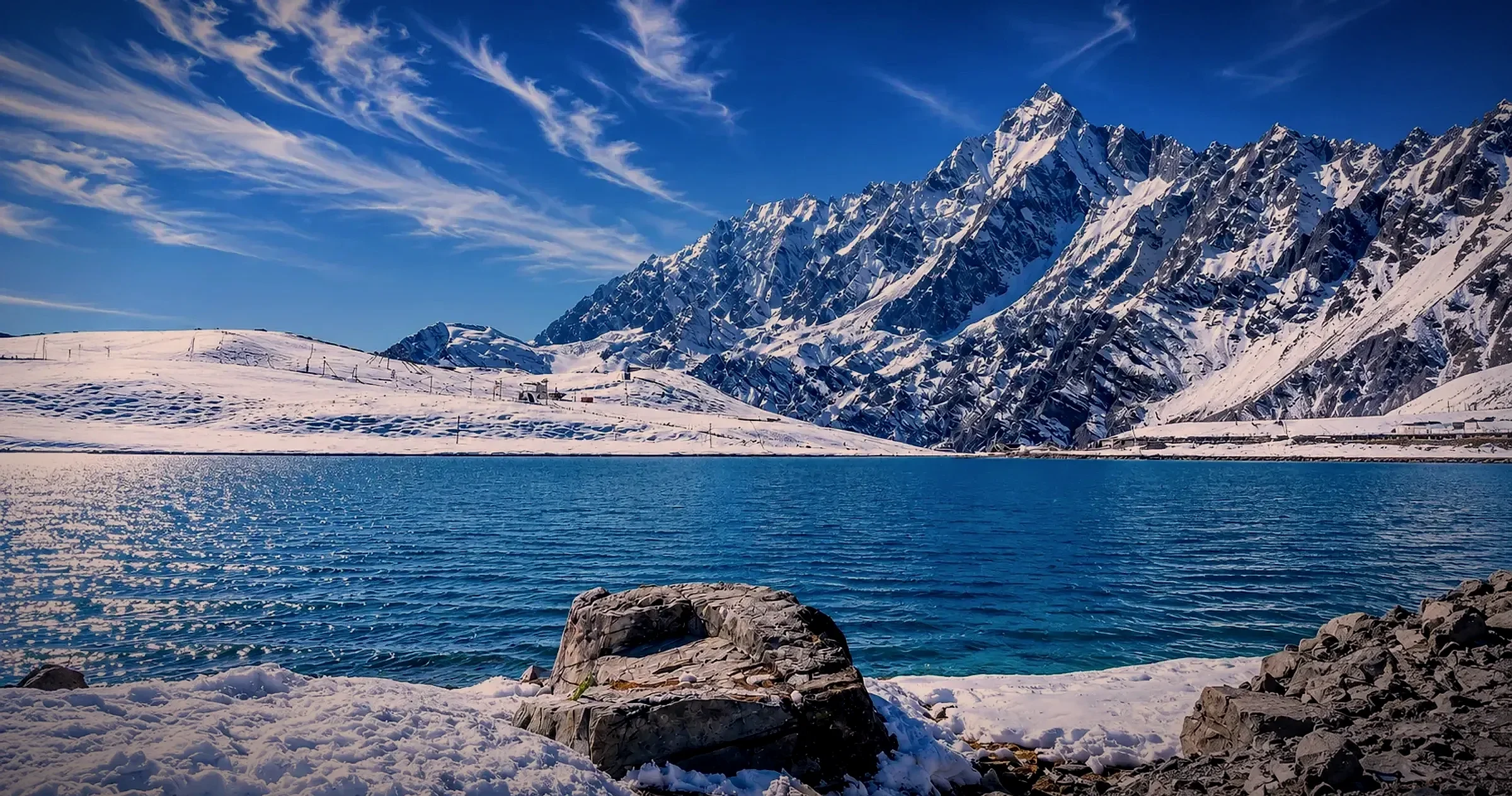 Snow-covered peaks above a glacial lake in the Tawang region, Arunachal Pradesh